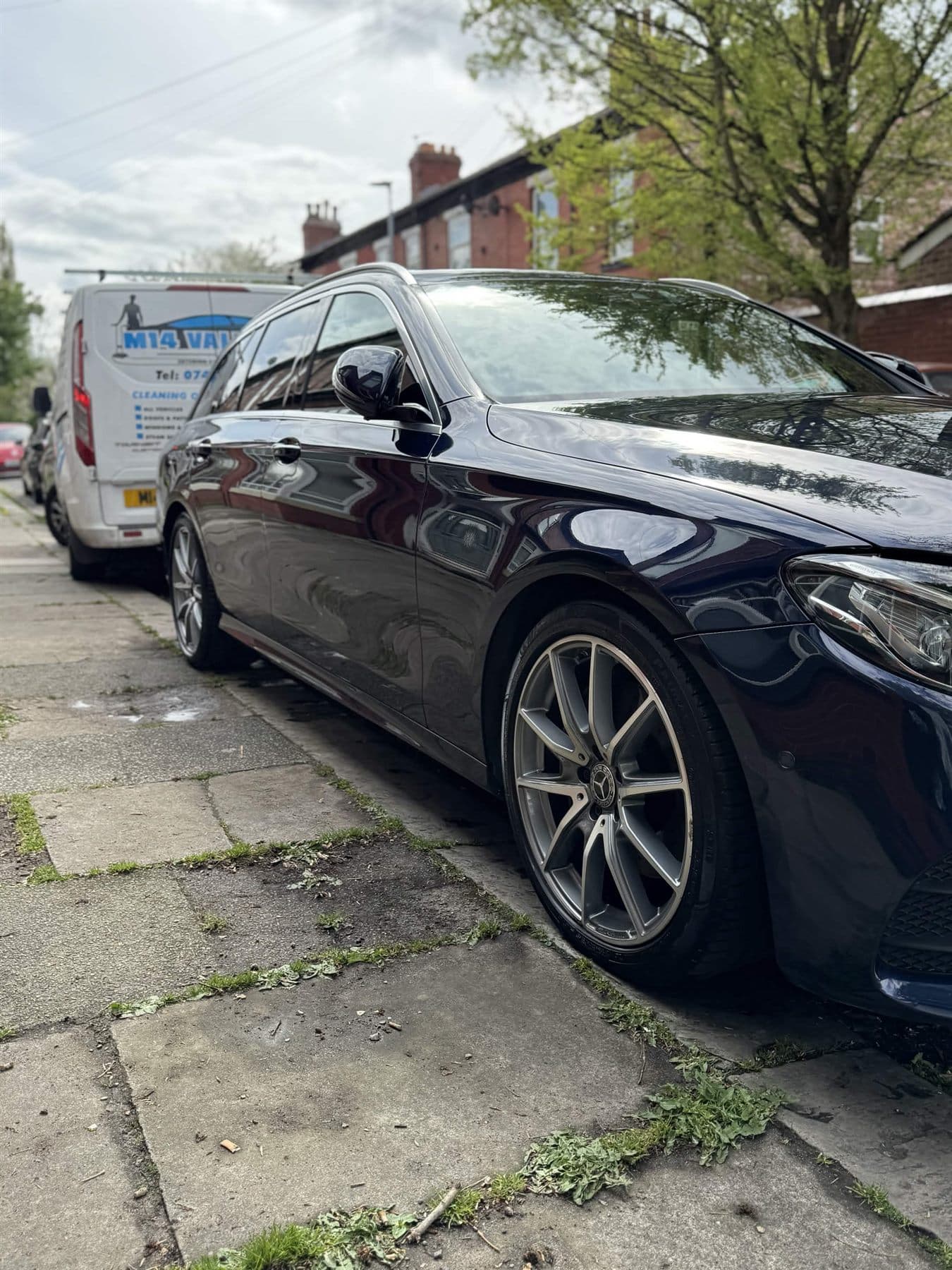 M14 Valeters van parked behind a clean black estate car
